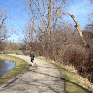 A jogger enjoys a trail at East Lansing's White Park, which was improved by a $225,000  grant in 2007, as well as a pavilion and softball field. Photo: Chelsea Mongeau.