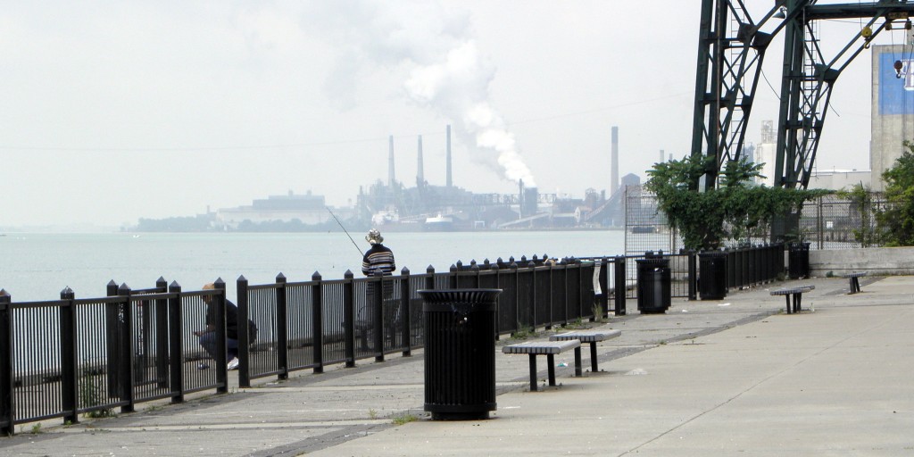 Fishing along the Detroit River near the Ambassador Bridge, looking back at Rouge pollution. Photo:Karen Schaefer.