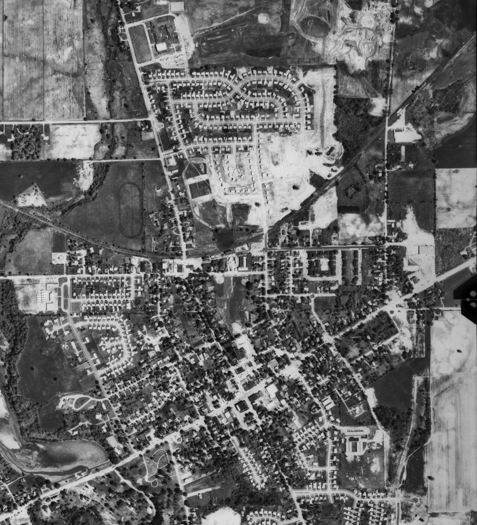 Saline, 1969: The obvious difference here is the new neighborhood that’s developed north of the city’s center. Though obviously not yet completed, this is the first significant expansion away from the center of Saline. Just a little further north and at the top of the picture is the city’s newest school. East of that is Saline’s former high school under construction.