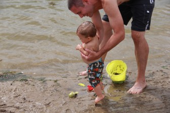 A young boy plays in the surf at a beach in Michigan's Sleepy Hollow State Park. Image: Kailiang Li