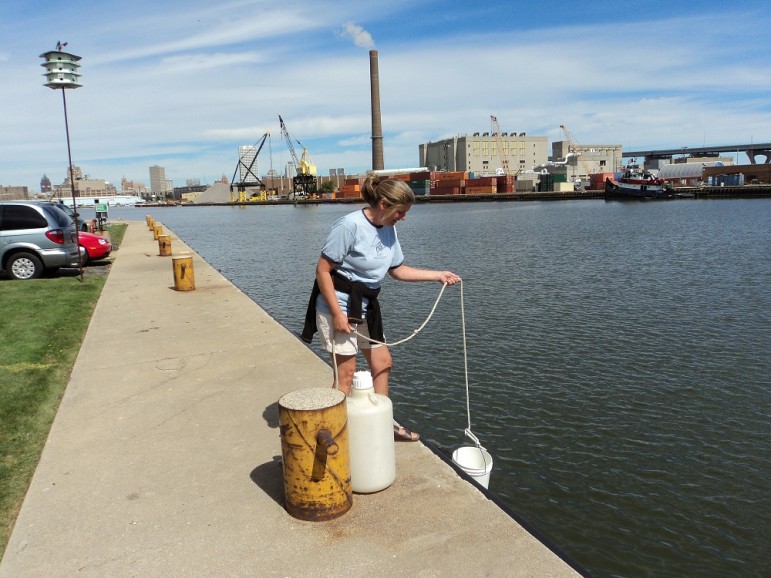 Sandra McLellan, professor and senior scientist at the University of Wisconsin-Milwaukee’s School of Freshwater Sciences, samples water in June off the school’s dock wall in the inner harbor of Milwaukee. She has found sewage migrating from old pipes through soil and into the stormwater lines that drain to lakes or streams. She says the problem is likely to occur in Madison and cities nationwide. Photo courtesy of Sandra McLellan.