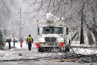 Utility crews work to restore power in North Lansing, Michigan, following a December 2013 ice storm (AP Photo/Lansing State Journal, Robert Killips)