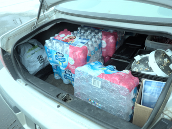 The Garcias' trunk filled with cases of water from Our Lady of Guadalupe. Image: Amanda Proscia