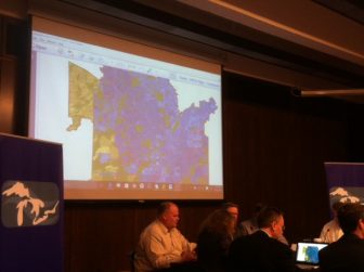 Representatives of the Great Lakes governors consider a map of Waukesha's proposed water needs. Image: Gary Wilson