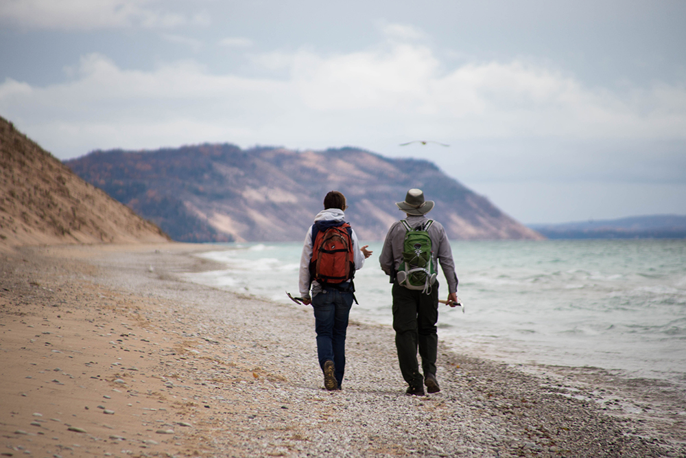 Williams and Ray walk along the Sleeping Bear Dunes coast looking for dead birds. Image: Samuel Corden