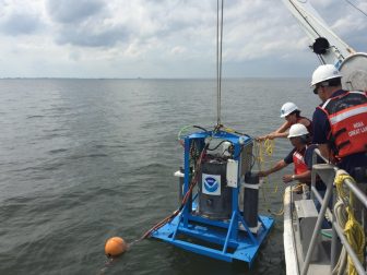 Deploying a second generation environmental sample processor. This device collects and analyzes water samples in near-real time, enhancing scientists’ understanding of the bloom’s toxicity. Image: NOAA GLERL