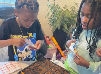 IMAGE: Deaf and hard-of hearing youth prepare seeds for a new community garden. Image courtesy of Jurmel Mitchell Sr. 