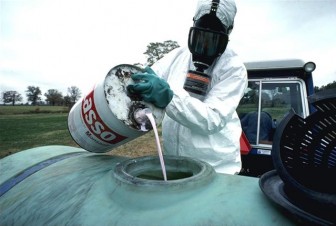 Hazardous herbicide being poured to be sprayed on food crops. Image: United States Department of Agriculture