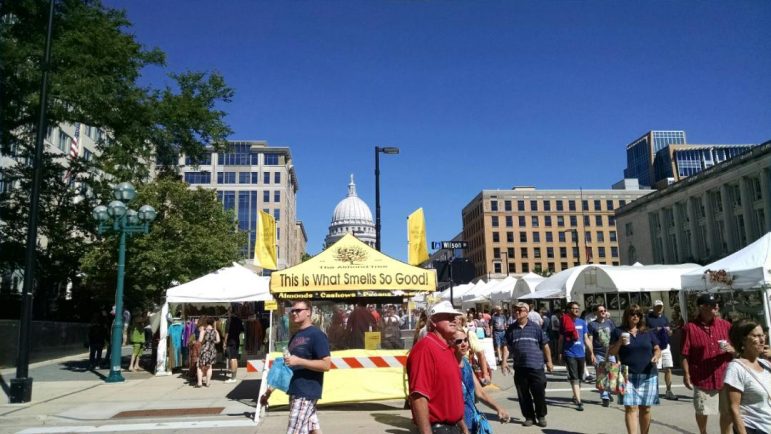 Is this a statement of support for Wisconsin state air pollution control legislation? Or just a pat on the back for state lawmakers? Naahh, it's just a well-placed tent selling nuts — almonds, cashews, pecans and peanuts -- during an arts fair and farmers market on a street in front of Wisconsin's Capitol in Madison. The building was completed in 1917. Image: Eric Freedman