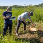 Student researchers Ava Whitlock and Brody Glei get ready to fly a drone equipped with a heat-sensitive camera to find rare eastern massasauga rattlesnakes. Image: Ruth Thorton/WKAR