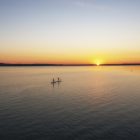 Paddle boarders cross Platte Lake, Michigan, where a decades-long campaign reduced algal blooms caused by runoff from a fish hatchery. Image: J. Carl Ganter/ Circle of Blue