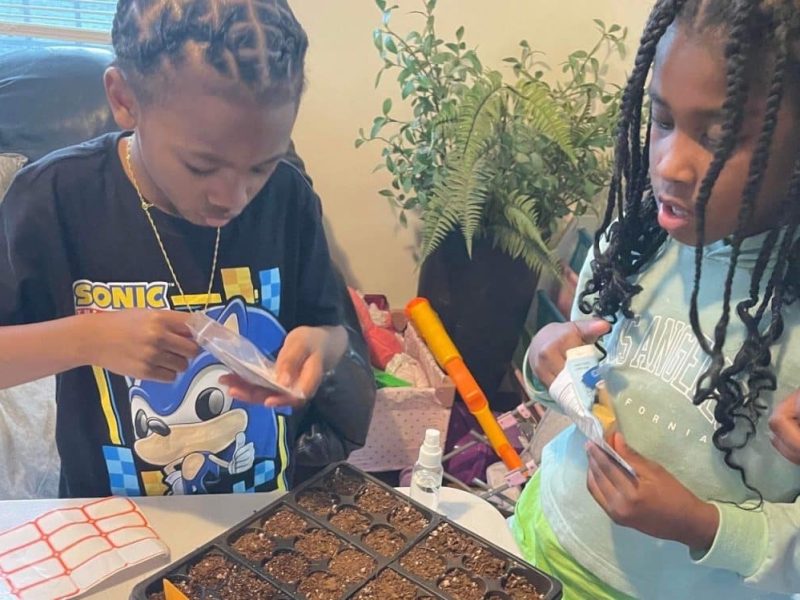 IMAGE: Deaf and hard-of hearing youth prepare seeds for a new community garden. Image courtesy of Jurmel Mitchell Sr.