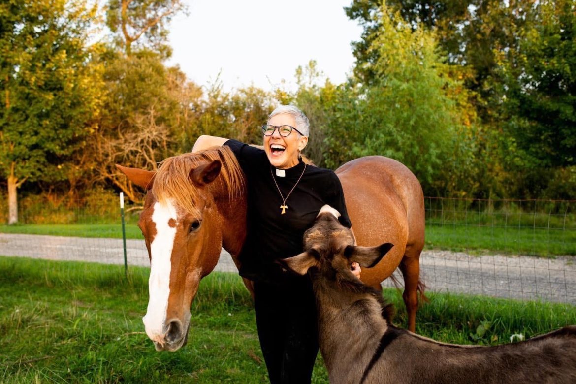 Attorney Ginny Mikita poses for a photo with her two farm animals