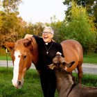 Attorney Ginny Mikita poses for a photo with her two farm animals