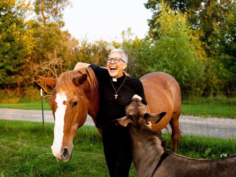 Attorney Ginny Mikita poses for a photo with her two farm animals