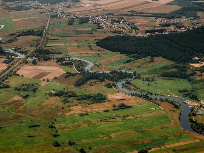 An overhead view of a large land mass that is split apart by multiple bodies of water