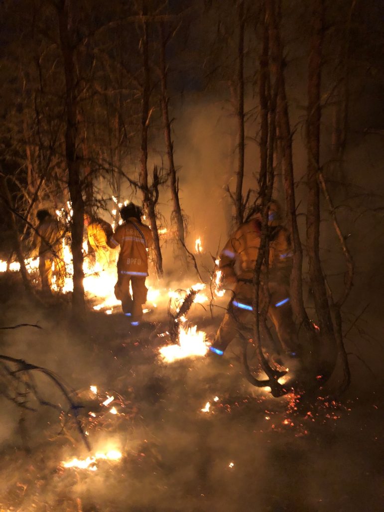Firefighters fighting a wildfire.