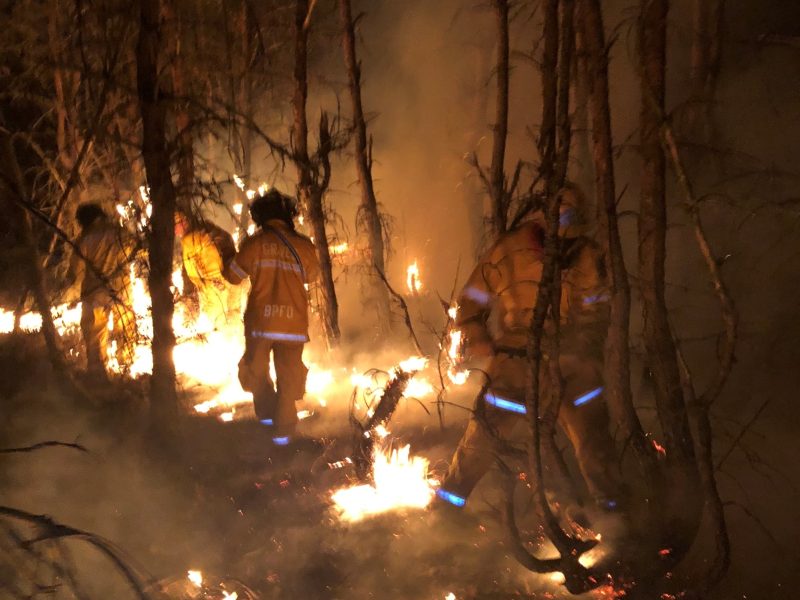 Firefighters fighting a wildfire.