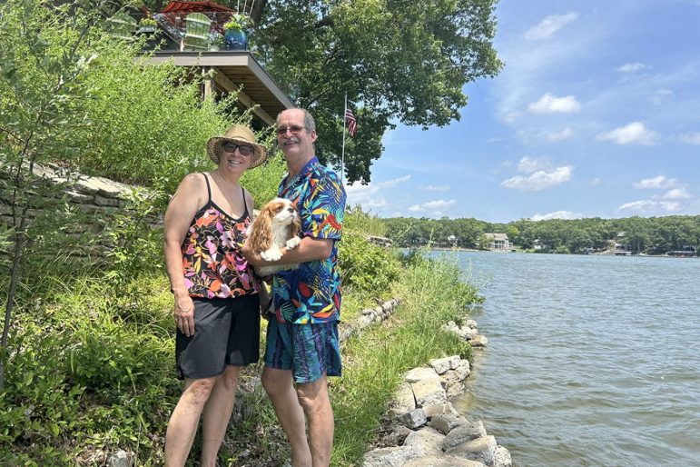 Sarah Cain and Brian Bradcoski pose for a photo outside.