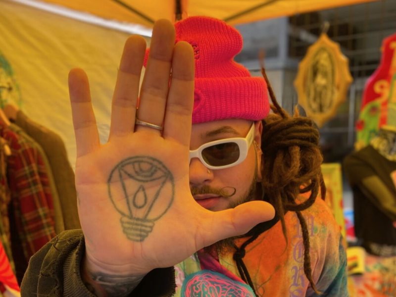 Hernandez poses for a photo with his tattooed hand at the focus of the image.