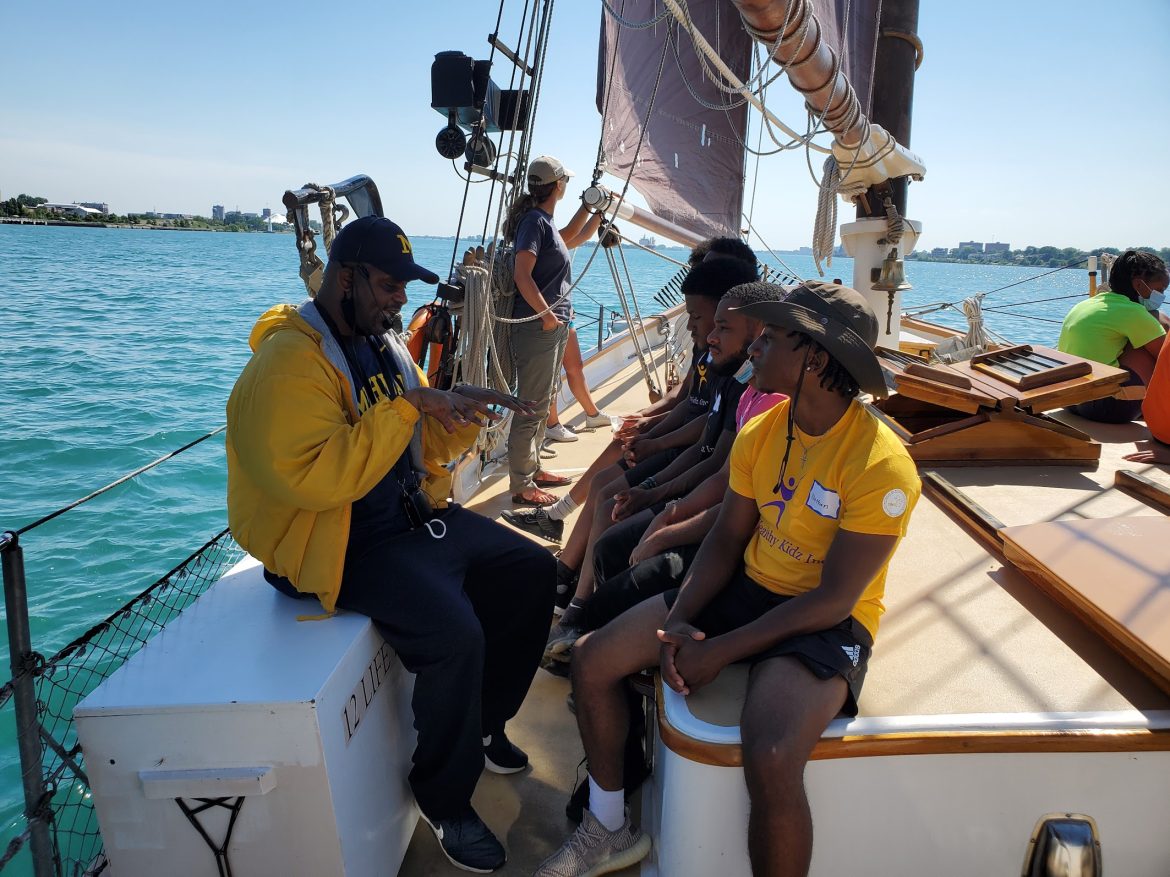 A group of people in a boat on the Detroit River.
