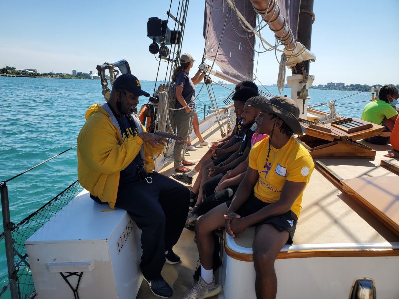 A group of people in a boat on the Detroit River.