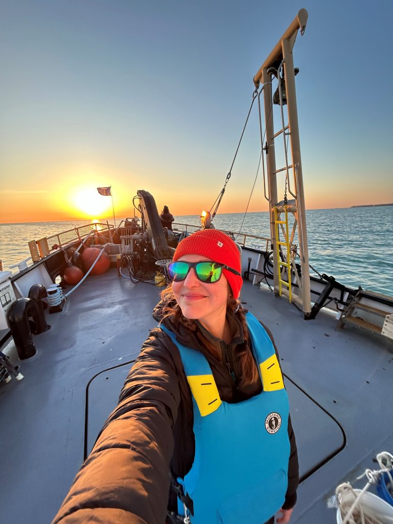 Ashley Lemke taking a selfie on a research vessel.