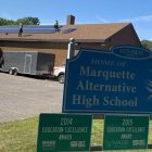 Solar panels being installed on the roof at Marquette Alternative High School.