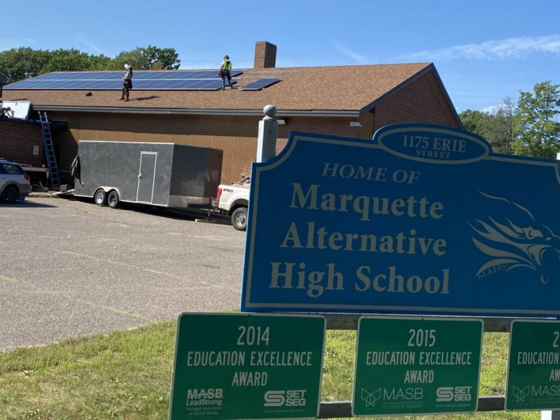 Solar panels being installed on the roof at Marquette Alternative High School.