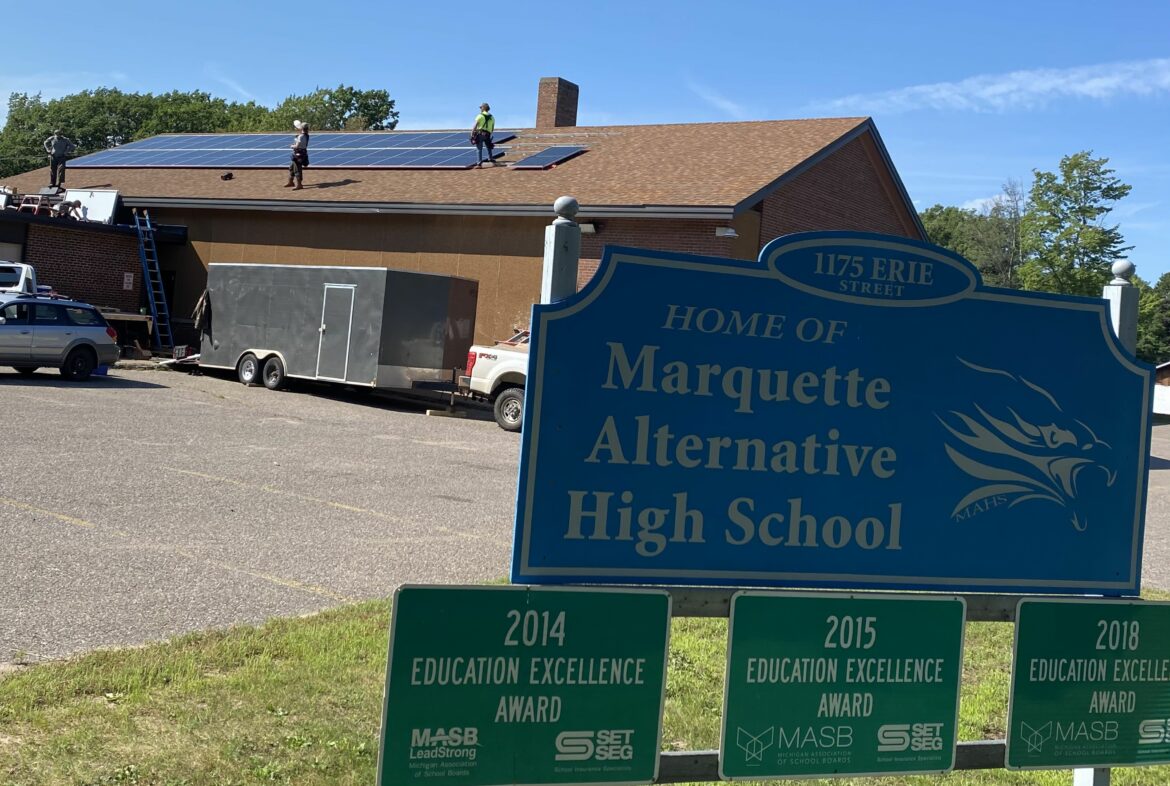 Solar panels being installed on the roof at Marquette Alternative High School.