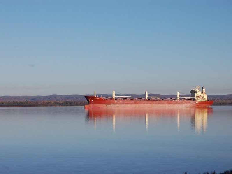 A red ship travels through the waterways near Sault Ste. Marie.