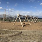 A playground constructed out of wood beams.