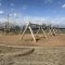A playground constructed out of wood beams.