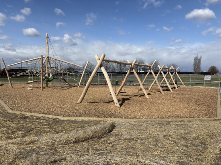 A playground constructed out of wood beams.