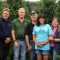 Wahmoff Farms family members stand in front of evergreen trees.