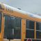 The side of a yellow school bus.