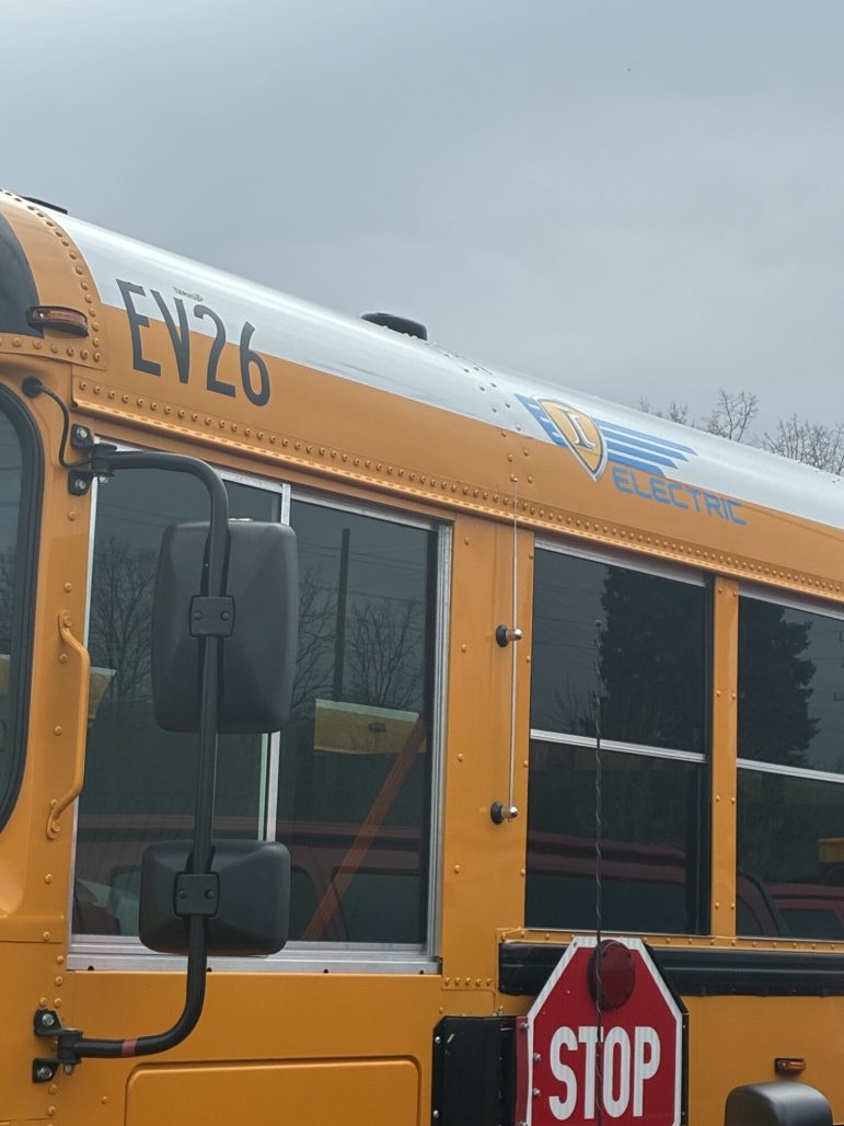 The side of a yellow school bus.